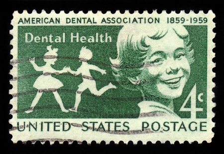 UNITED STATES OF AMERICA - CIRCA 1959: a stamp printed in the USA shows Children, Dental Health, Centenary of the American Dental Association, circa 1959のeditorial素材
