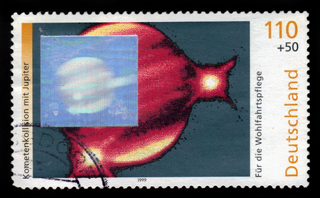 GERMANY - CIRCA 1999: a stamp printed in Germany shows comet collision with Jupiter, circa 2003のeditorial素材
