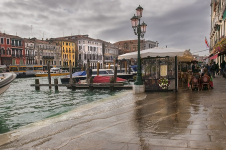 flooded with water promenade of Grand Canal in the rain, Venice, Italyの写真素材