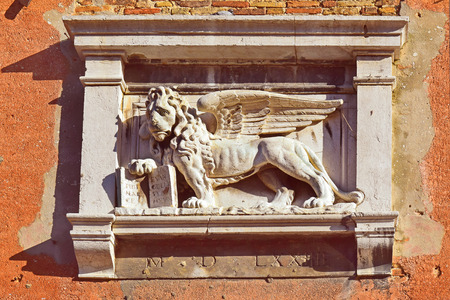 winged lion of St. Mark, symbol of Venice, decorative detail on the facade of one of palacesの写真素材