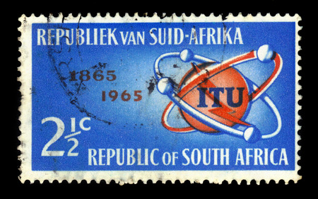 South Africa - CIRCA 1965: A stamp printed by South Africa shows emblem of I.T.U. (International Telecommunication Union), series century, circa 1965のeditorial素材