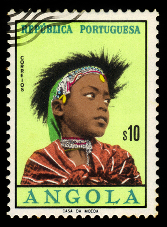 Portuguese Angola - CIRCA 1961: A stamp printed in Portugal shows woman coiffures of different angolan tribes, issued for use in Portuguese Angola, series girls of Angola, circa 1961のeditorial素材