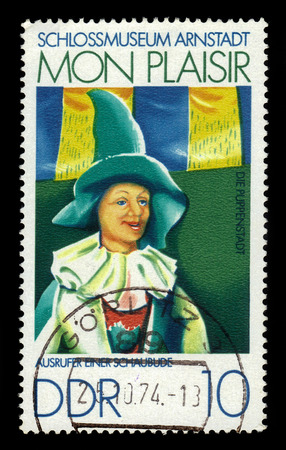 GERMANY - CIRCA 1974: a stamp printed in the Germany, Democratic Republic (DDR)  shows painting by Manfred Gottschall, crier of a show booth, Castle Museum Of Arnstadt "Mon Plaisir", circa 1974のeditorial素材