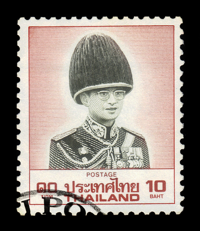 Thailand - CIRCA 1988: A stamp printed in Thailand shows portrait King Bhumibol Adulyadej in military uniform, King of Thailand ( King Rama IX ), circa 1988のeditorial素材