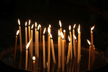 burning memorial candles in the templeの写真素材