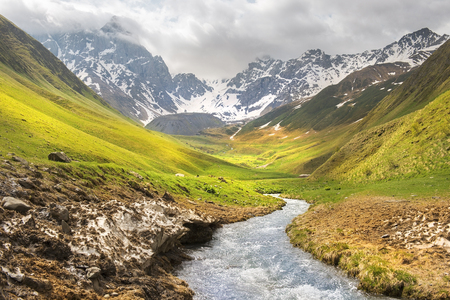picturesque mountain landscape wiht Chauhi River and Caucasus mountain range, Juta valley, Kazbegi region, Georgiaの写真素材