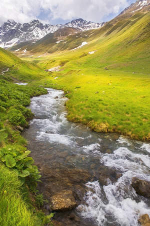 picturesque mountain landscape wiht Chauhi River and Caucasus mountain range, Juta valley, Kazbegi region, Georgiaの写真素材