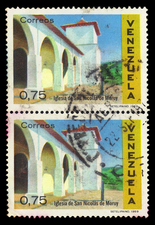 VENEZUELA - CIRCA 1969: A stamp printed in Venezuela shows Saint Nicholas church in Moruy, Venezuela, series colonial architecture, circa 1969のeditorial素材