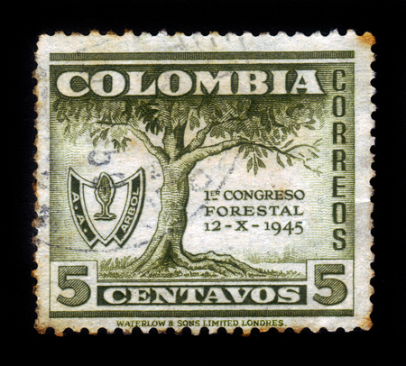 Colombia - circa 1949: A stamp printed in Colombia shows tree and emblem of first forest congress in Bogota, Colombia, circa 1949のeditorial素材