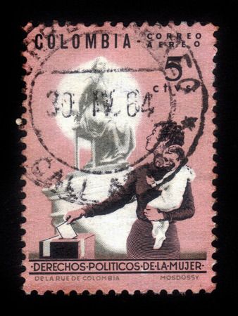 Colombia - circa 1964: A stamp printed in Colombia shows mother and children at the polling station, issued to publicize women's political rights, circa 1964のeditorial素材
