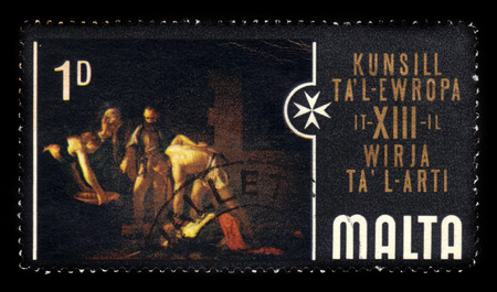 Malta - CIRCA 1970: A stamp printed in Malta shows the beheading of Saint John the Baptist is an oil painting by the Italian artist Caravaggio in St John's Co-Cathedral Malta, circa 1970のeditorial素材