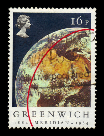 UNITED KINGDOM - CIRCA 1984: A stamp printed in UK shows portrait of Elizabeth II and Earth (View from Apollo 11), inscriptions Greenwich Meridian, series Ñentenery of the Greenwich Meridian, circa 1984のeditorial素材