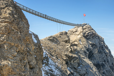 the world's first suspension bridge connecting two mountain peaks, Peak Walk at Glacier 3000 in Switzerlandの写真素材