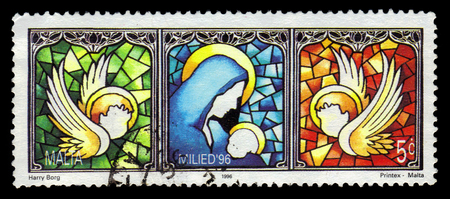 Malta - CIRCA 1996: A stamp printed in Malta shows Mary and baby Jesus, stained glass window, Christmas (1996), circa 1996のeditorial素材
