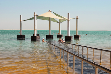 Dead Sea, Ein Bokek, Israel - october 19: vacationers and tourists bathe in the Dead Sea on october 19, 2017 in Ein Bokek, Dead Sea, Israelのeditorial素材