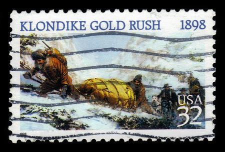 USA - CIRCA 1998: a stamp printed in USA shows american prospectors ascending the Chilkoot Pass, 1898, 100th anniversary, circa 1998のeditorial素材