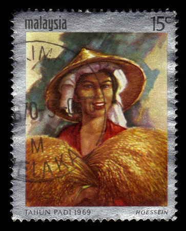 MALAYSIA - CIRCA 1969: A stamp printed in Malaysia shows Tahun Padi artwork by malaysian artist Hoessein Enas, international rice year, circa 1969のeditorial素材