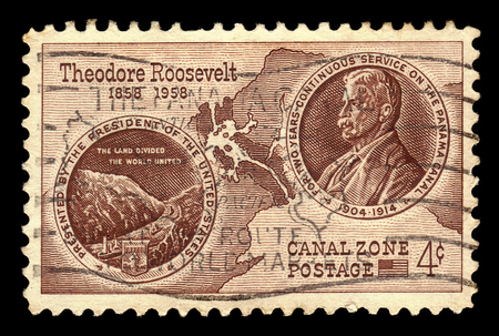 Territories of the United States, Canal Zone (Panama) - CIRCA 1958: A stamp printed in the United States shows view of the Panama Canal and portrait Theodore Roosevelt, circa 1958のeditorial素材
