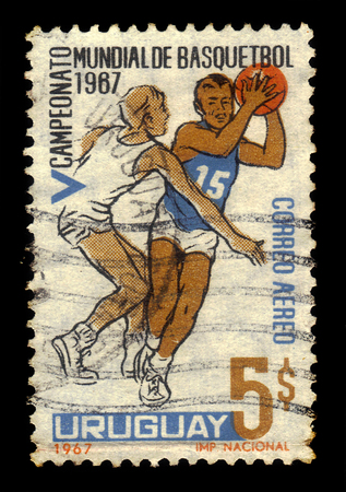 URUGUAY - CIRCA 1967: A stamp printed in Uruguay shows basketball players in action, series World Basketball Championships, Montevideo 1967, circa 1967のeditorial素材