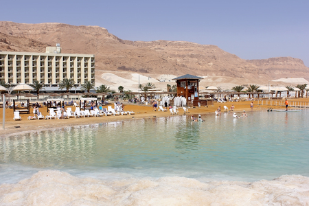 Dead Sea, Ein Bokek, Israel - March 18: vacationers and tourists bathe in the Dead Sea on the background of luxury hotels on March 18, 2018のeditorial素材