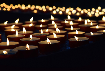 burning memorial candles on the dark backgroundの写真素材