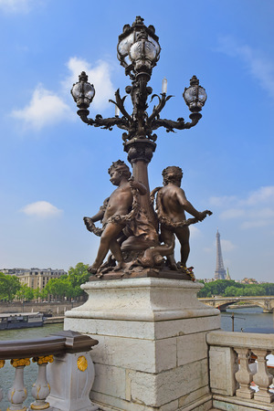 Pont Alexandre III bridge decorated with ornate Art Nouveau lamps and sculptures and Eiffel Tower in the distance, Paris, Franceのeditorial素材