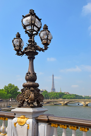 Pont Alexandre III bridge decorated with ornate Art Nouveau lamps and sculptures and Eiffel Tower in the distance, Paris, Franceのeditorial素材