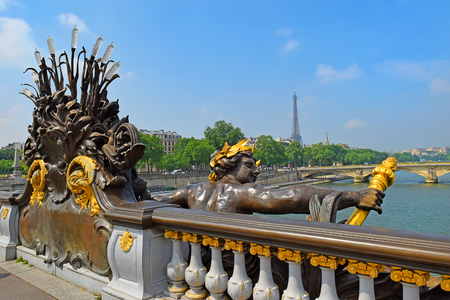 Pont Alexandre III bridge decorated with ornate Art Nouveau lamps and sculptures and Eiffel Tower in the distance, Paris, Franceのeditorial素材