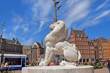 Amsterdam, North Holland, The Netherlands - May 20 2018: one of the two lion sculptures as part of  the National Monument (designed by architect Oud, erected in 1956) on Dam Square to memorialize the victims of the World War IIのeditorial素材