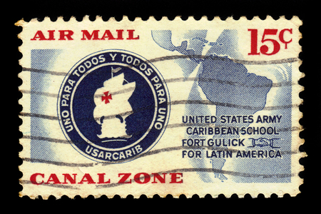 CANAL ZONE, PANAMA - CIRCA 1961: a stamp printed in the USA shows the Emblem Of The U.S. Army Caribbean School, circa 1961のeditorial素材