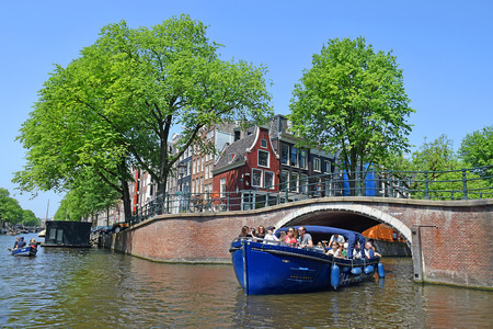 Amsterdam, North Holland, The Netherlands - May 20 2018: trip through the picturesque canals of Amsterdam. Amsterdam is the capital and most populous city of the Netherlandsのeditorial素材