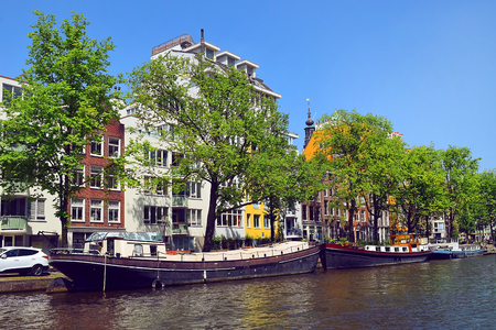 trip through the picturesque canals of Amsterdam. Amsterdam is the capital and most populous city of the Netherlandsの写真素材