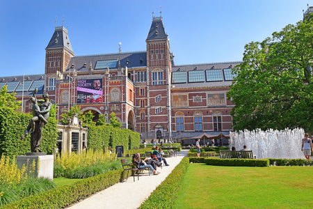 Amsterdam, North Holland, The Netherlands - May 20, 2018: tourists on the pier near the building of the Hermitage Amsterdam, branch museum of the Hermitage Museum of Saint Petersburg, Russia, located on the banks of the Amstel riverのeditorial素材