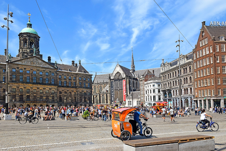 Amsterdam, The Netherlands - May 21, 2018: tourist and locals visiting the Dam square with in the background the old City Hall and now the Royal Palace. this is one of the most popular meeting points in Amsterdamのeditorial素材