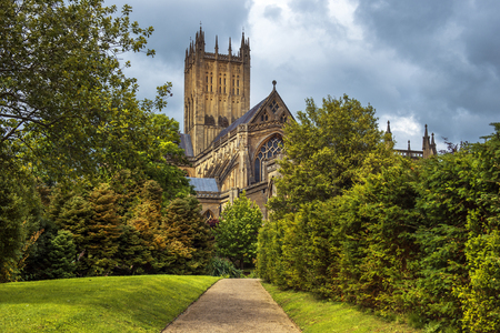 Wells Cathedral (Cathedral Church of Saint Andrew), Wells Abbey and park on sunny day, Somerset, Englandのeditorial素材