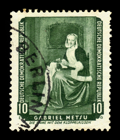 German Democratic Republic (East Germany) - circa 1959: A stamp printed in German Democratic Republic shows "The Needlewoman" (Lacemaker) by Gabriel Metsu, series returned paintings from the Dresden gallery, circa 1959のeditorial素材