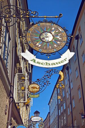 Salzburg, Austria - May 23, 2018 : advertising sign for shops on Getraydegasse, stylized as medieval coats of arms of various guildsのeditorial素材