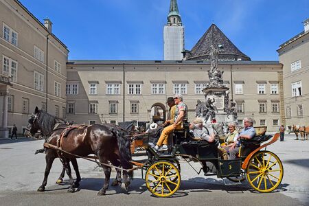 Salzburg, Austria - May 24, 2019: horse driven carriage with tourists at the Domplatz square, Salzburgのeditorial素材