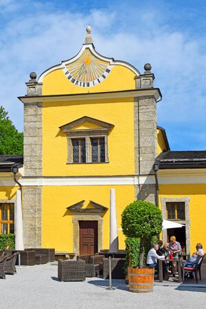 Salzburg, Austria - May 25, 2019 : Hellbrunn Palace (Schloss Hellbrunn), summer residence of the Archbishop of Salzburg, outbuilding with a sundial on the facadeのeditorial素材