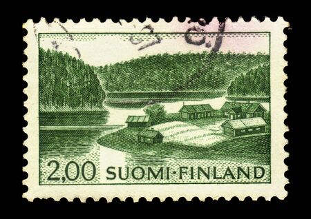 FINLAND - CIRCA 1974: stamp printed by Finland, shows village in an idyllic rural location on the lake shore, Finland, circa 1974のeditorial素材