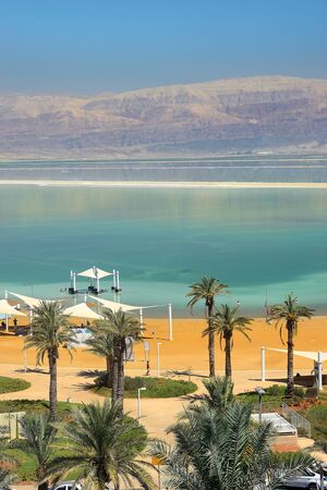 Dead Sea, Ein Bokek, Israel - July 14, 2019 : vacationers and tourists bathe in the Dead Sea, public beach at the resort Ein Bokekのeditorial素材