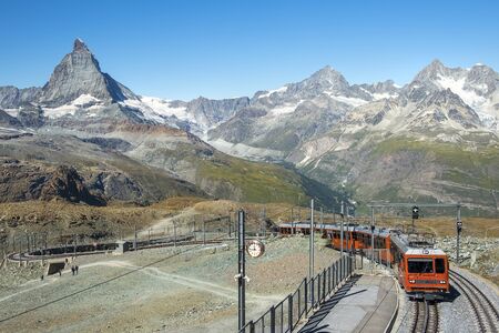 ZERMATT, SWITZERLAND - September 03, 2019: red train on the background of Matterhorn peak in the Swiss Alps (Pennine Alps)のeditorial素材