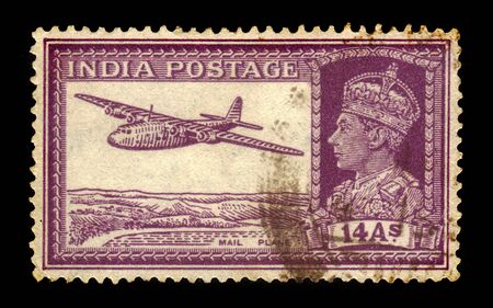 INDIA - CIRCA 1940: A stamp printed in India shows a portrait of an King George VI and mail plane, circa 1940のeditorial素材