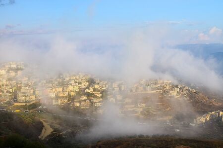 biblical village Cana of Galilee ( Kafr Kanna ) in morning fog, Nazareth in Israelの写真素材