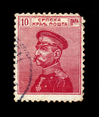 SERBIA - CIRCA 1911: A stamp printed in Serbia, shows portrait of the first King of Serbs, Croats and Slovenes Peter I Karadjordjevic (1844 - 1921), red, circa 1911のeditorial素材