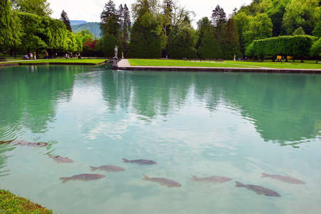 Salzburg, Austria - May 25, 2019 : pond with giant common carps and sculptures in the park of the Hellbrunn Palace - summer residence of the Archbishop of Salzburgのeditorial素材