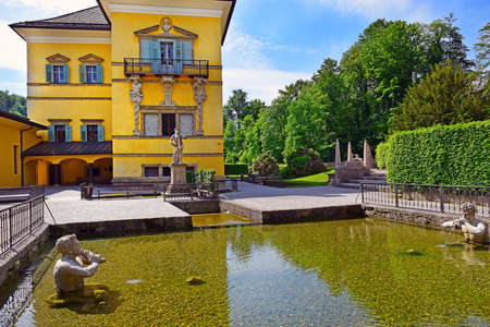 Salzburg, Austria - May 25, 2019 : Hellbrunn Palace (Schloss Hellbrunn) and sculptures at the pond in Public Gardens of Hellbrunn Palace in Salzburgのeditorial素材