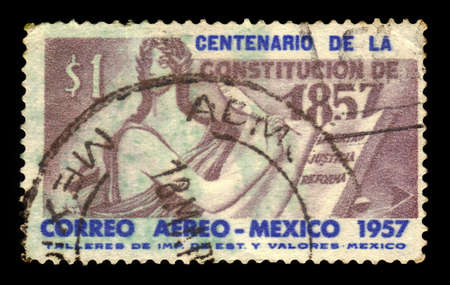 MEXICO - CIRCA 1957: a stamp printed in the Mexico shows Allegorical figure writing the law, Centenary of 1857 Constitution, circa 1957のeditorial素材