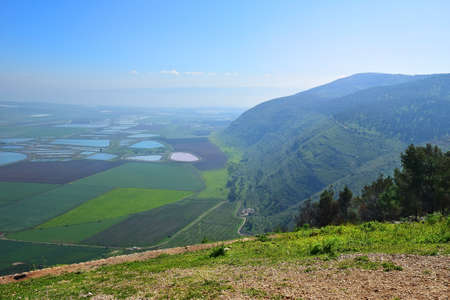 landscape with a view on Jezreel Valley (Valley of Megiddo) from Mount Gilboa. plowed land, colorful fields, fish ponds. Lower Galilee region in Israelの写真素材