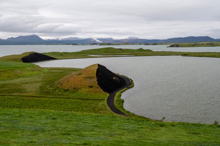 amazing landscape of Myvatn lake in Northern Iceland with islet of volcanic pseudo craterの写真素材